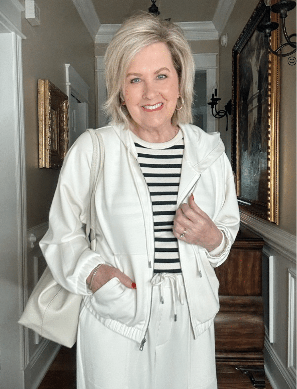 Over 50 Fashion Blogger, Tania Stephens is wearing a neutral outfit consisting of an ivory zip hoodie and striped top from Target